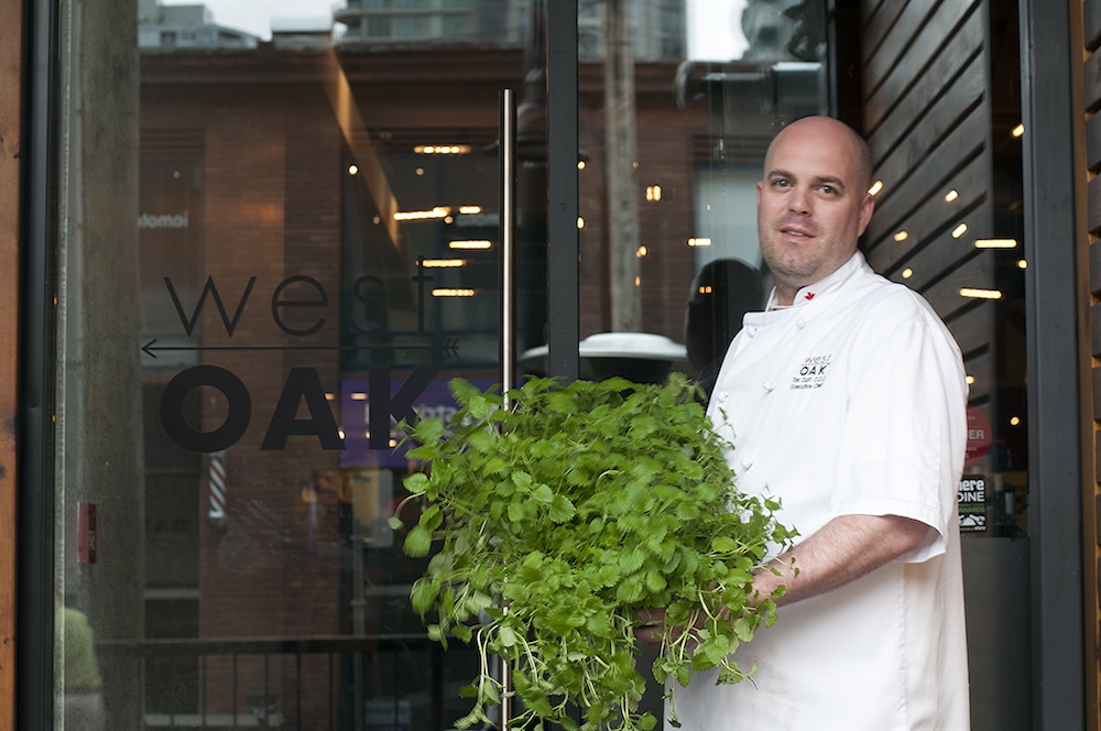 Chef Tim Cuff holding Urban Cultivator grown herbs